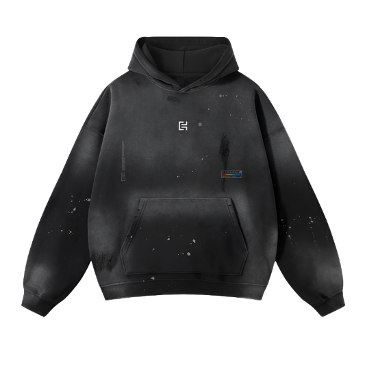 The UH013 Hoodie by ODMPOD exudes vintage vibes with its black hue, white paint splatter designs, and a small square logo on the chest. This unisex fleece hoodie offers modern comfort with a front pocket and subtle decorative elements near the bottom and on the arm.