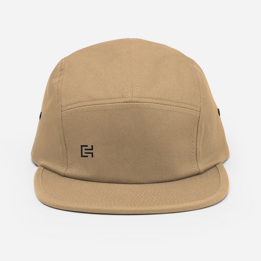 The C3 - Origem, version MVP Design Elite Select by C3 is a tan-colored, low profile camper style cap featuring a black geometric logo on the front. It has a curved brim, ventilation eyelets on the sides, and a nylon strap clip closure. The product is showcased against a white background.