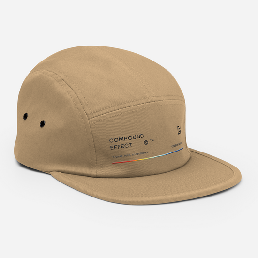 A beige, low-profile C3 Five Panel Cap with a flat brim and ventilation grommets on the side. It features "COMPOUND EFFECT" text on the front, a small logo with colorful lines, and a handy nylon strap clip closure for easy adjustment.