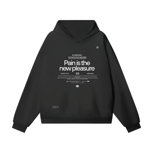 Introducing the ODMPOD Oversize Heavyweight Hidden Pocket Fleece Hoodie - 460 GSM in black, featuring bold white text on the front that declares, "Pain is the new pleasure," complemented with smaller text and logos beneath. This hoodie includes a practical hidden front pocket and a hood for added comfort. For precise sizing, please refer to our size chart for accurate chest measurements and sleeve length.